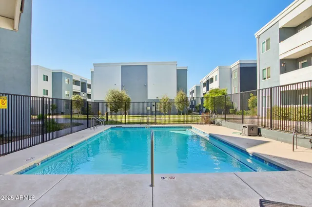 a swimming pool with outdoor seating and yard