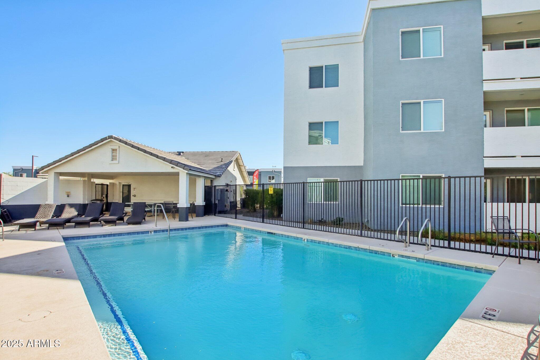 12925 West Greenway Road, Unit 5 El Mirage, AZ 85335 - Photo 23 of 30 a swimming pool view with seating space