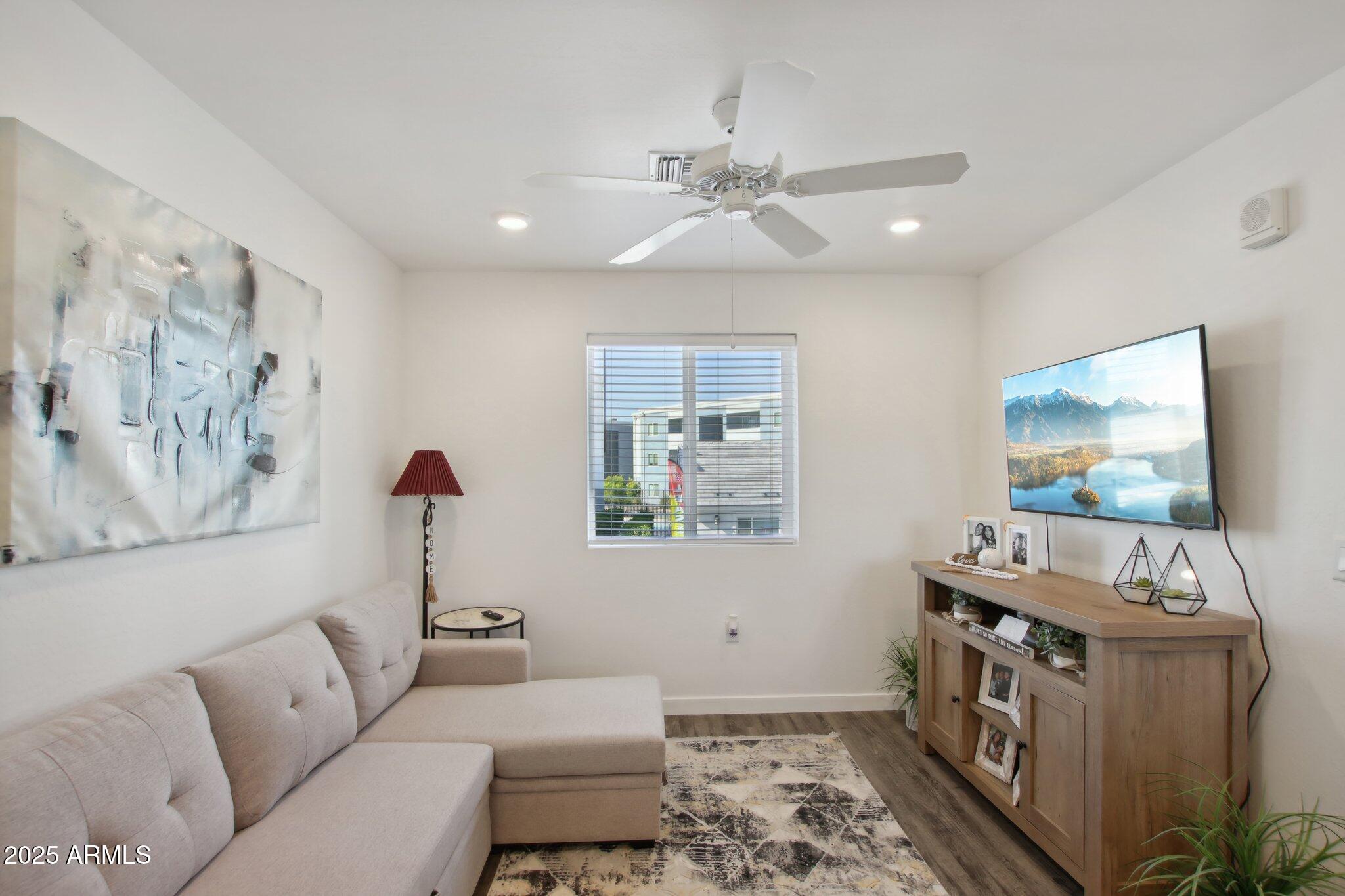12925 West Greenway Road, Unit 5 El Mirage, AZ 85335 - Photo 3 of 30 a living room with furniture and a flat screen tv