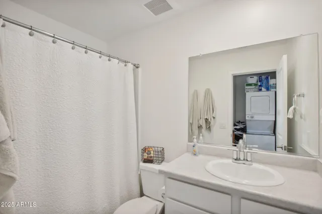 a bathroom with a sink mirror and a toilet