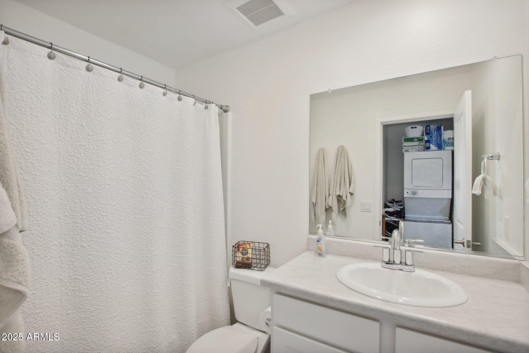 12925 West Greenway Road, Unit 5 El Mirage, AZ 85335 - Photo 10 of 30 a bathroom with a sink mirror and a toilet