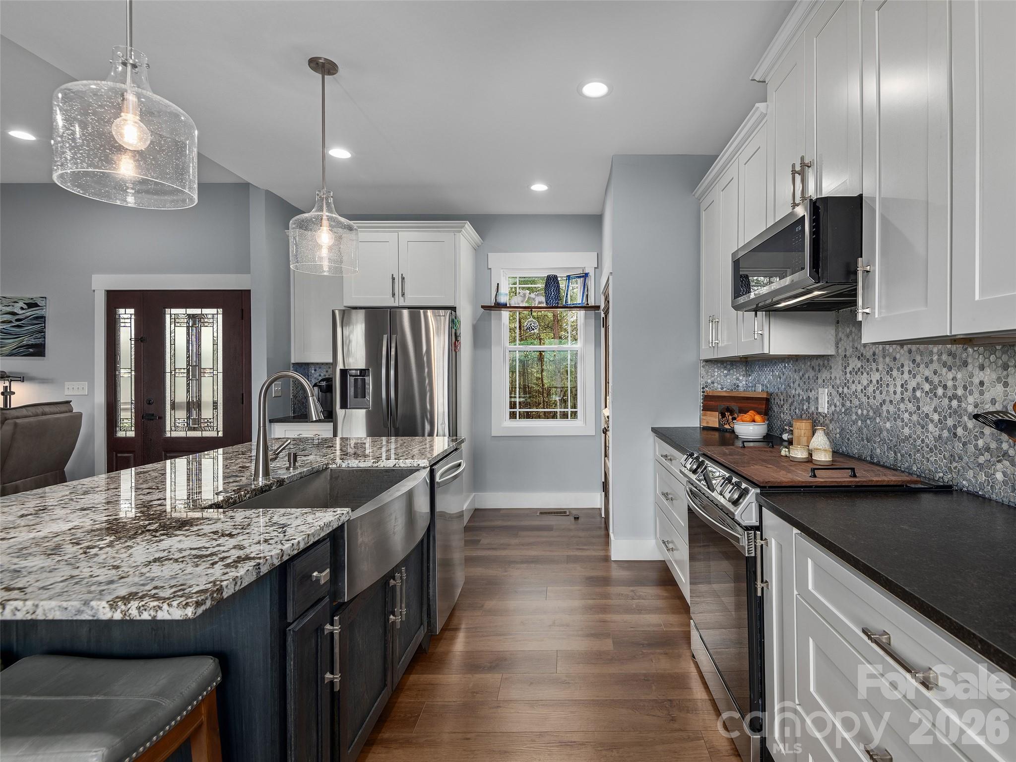 3244 Lake Adger Parkway Mill Spring, NC 28756 - Photo 13 of 44 a kitchen with stainless steel appliances granite countertop a sink stove and refrigerator