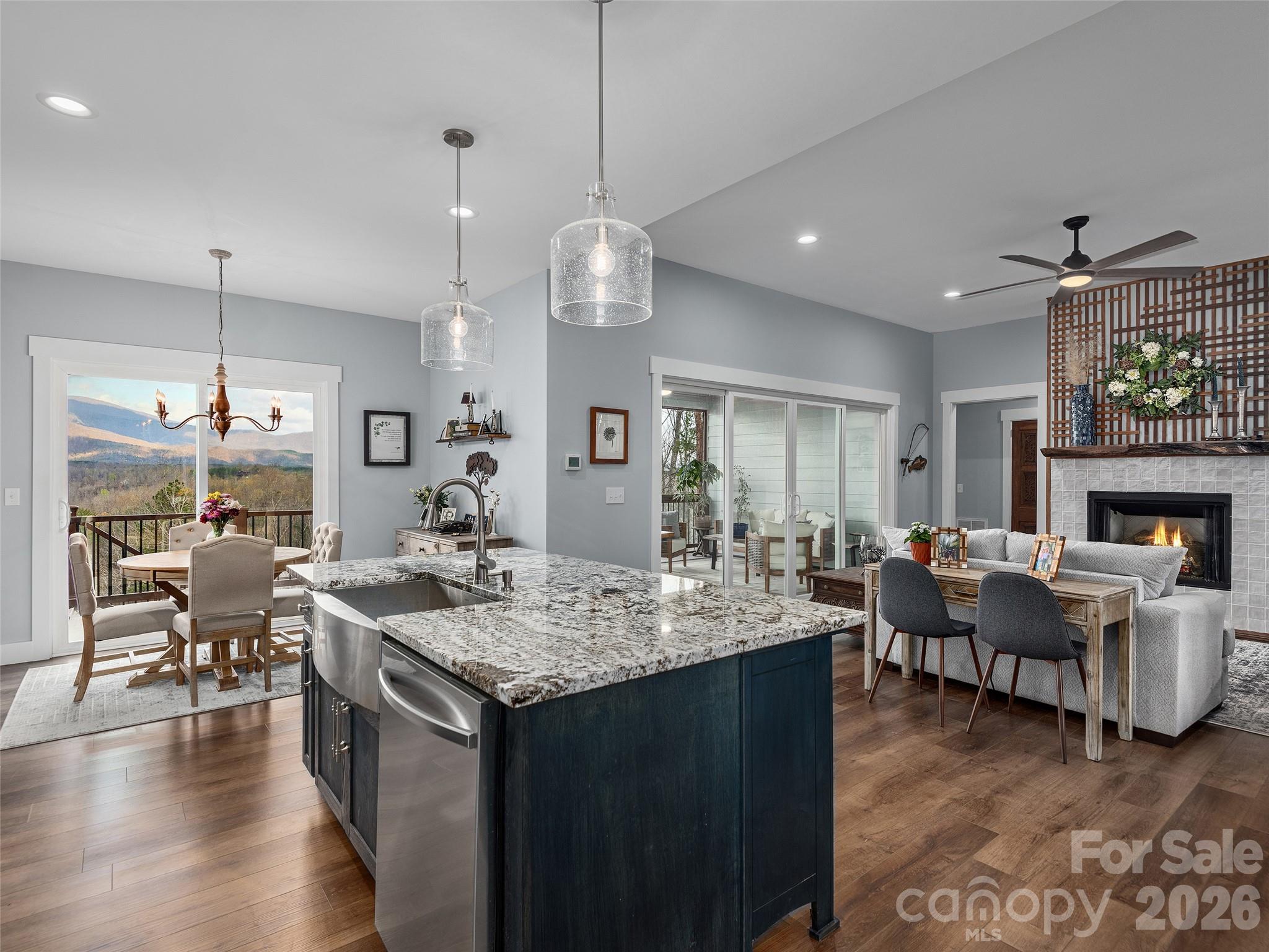 3244 Lake Adger Parkway Mill Spring, NC 28756 - Photo 14 of 44 a view of a dining room and livingroom with furniture wooden floor a chandelier
