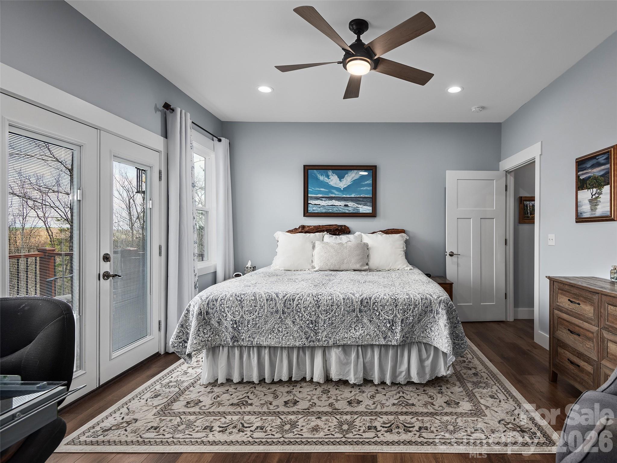 3244 Lake Adger Parkway Mill Spring, NC 28756 - Photo 20 of 44 a spacious bedroom with a bed and a flat screen tv