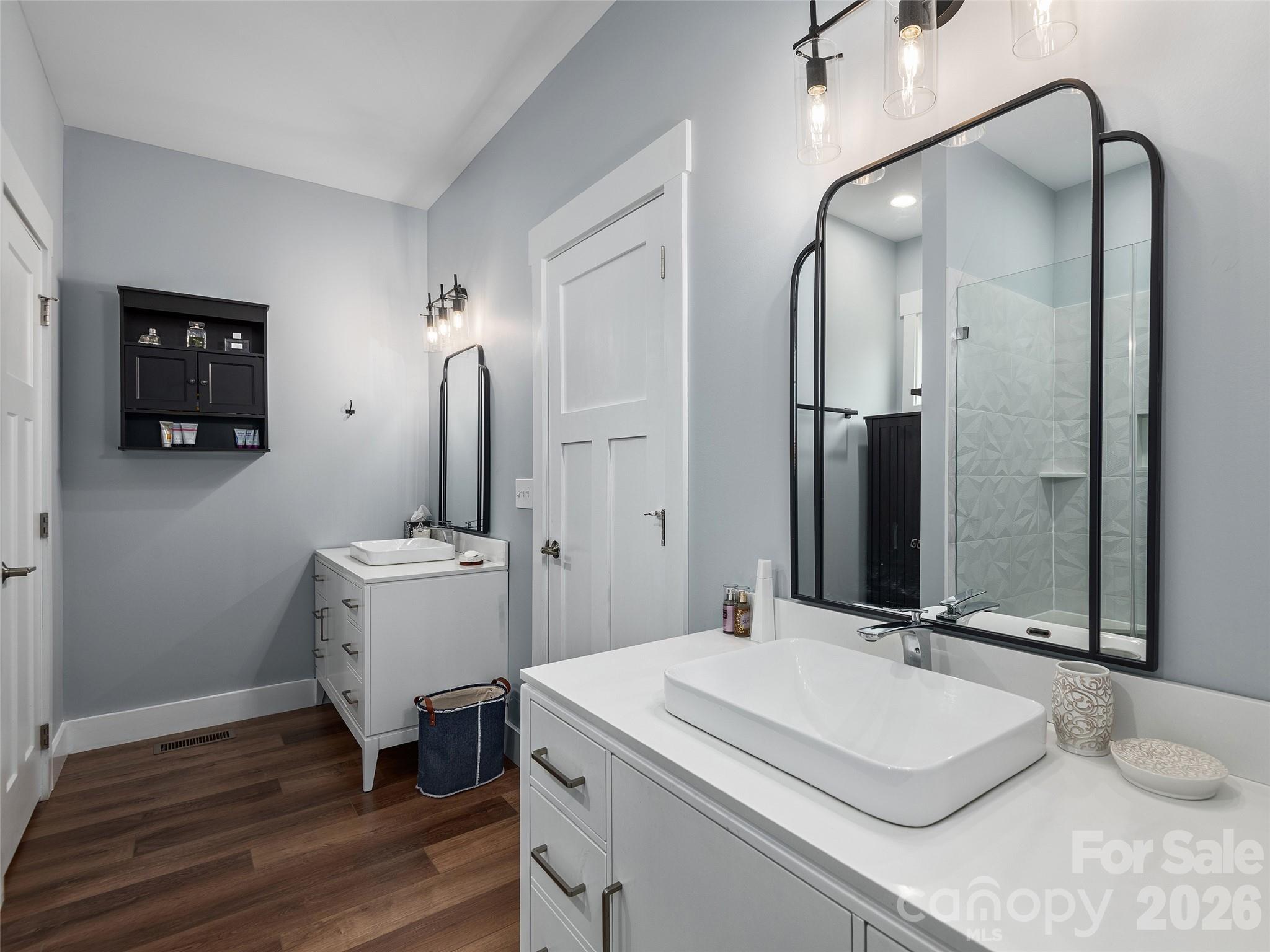 3244 Lake Adger Parkway Mill Spring, NC 28756 - Photo 23 of 44 a bathroom with a sink and a mirror