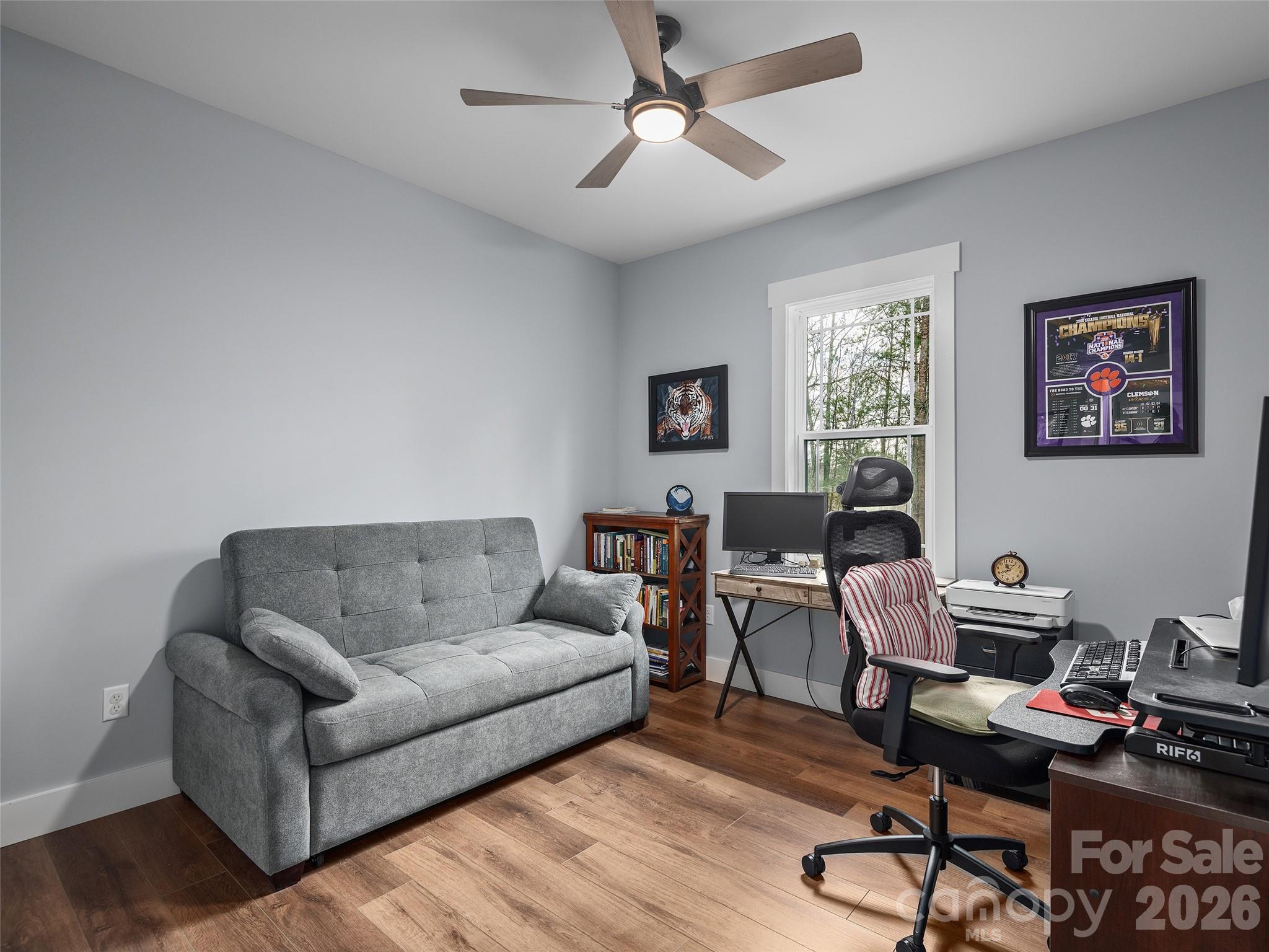 3244 Lake Adger Parkway Mill Spring, NC 28756 - Photo 29 of 44 a living room with furniture a desk and chair with wooden floor
