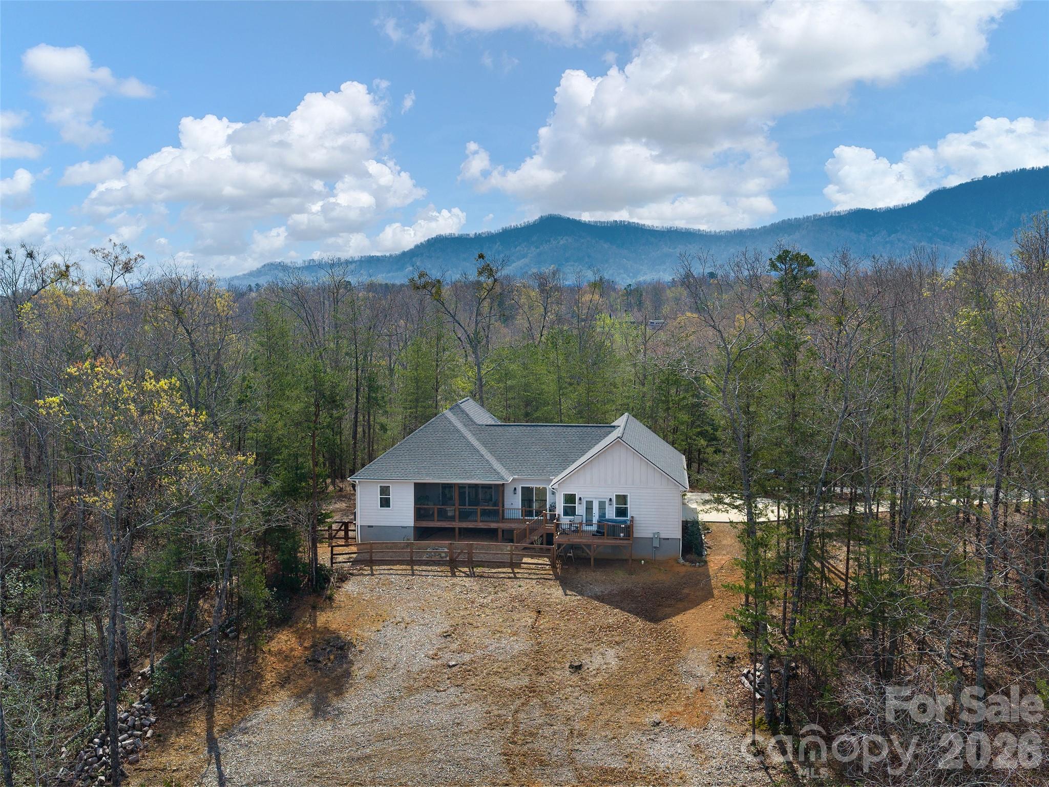 3244 Lake Adger Parkway Mill Spring, NC 28756 - Photo 35 of 44 a front view of a house with a yard and large trees