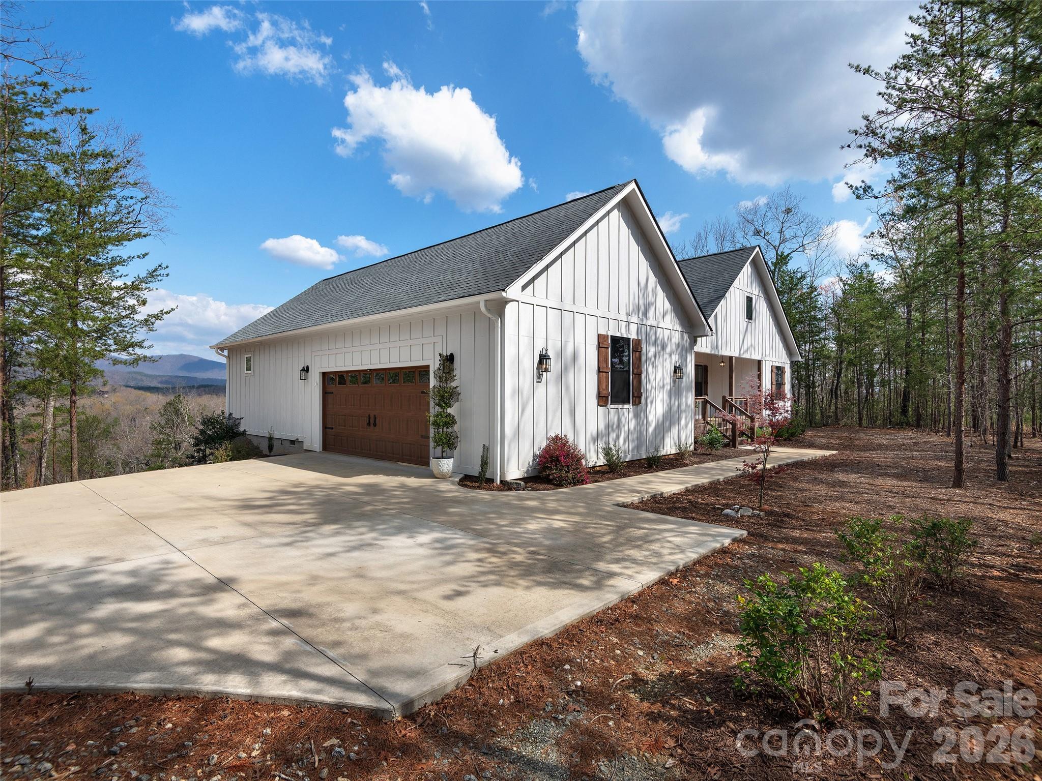 3244 Lake Adger Parkway Mill Spring, NC 28756 - Photo 36 of 44 a view of a house with backyard and trees