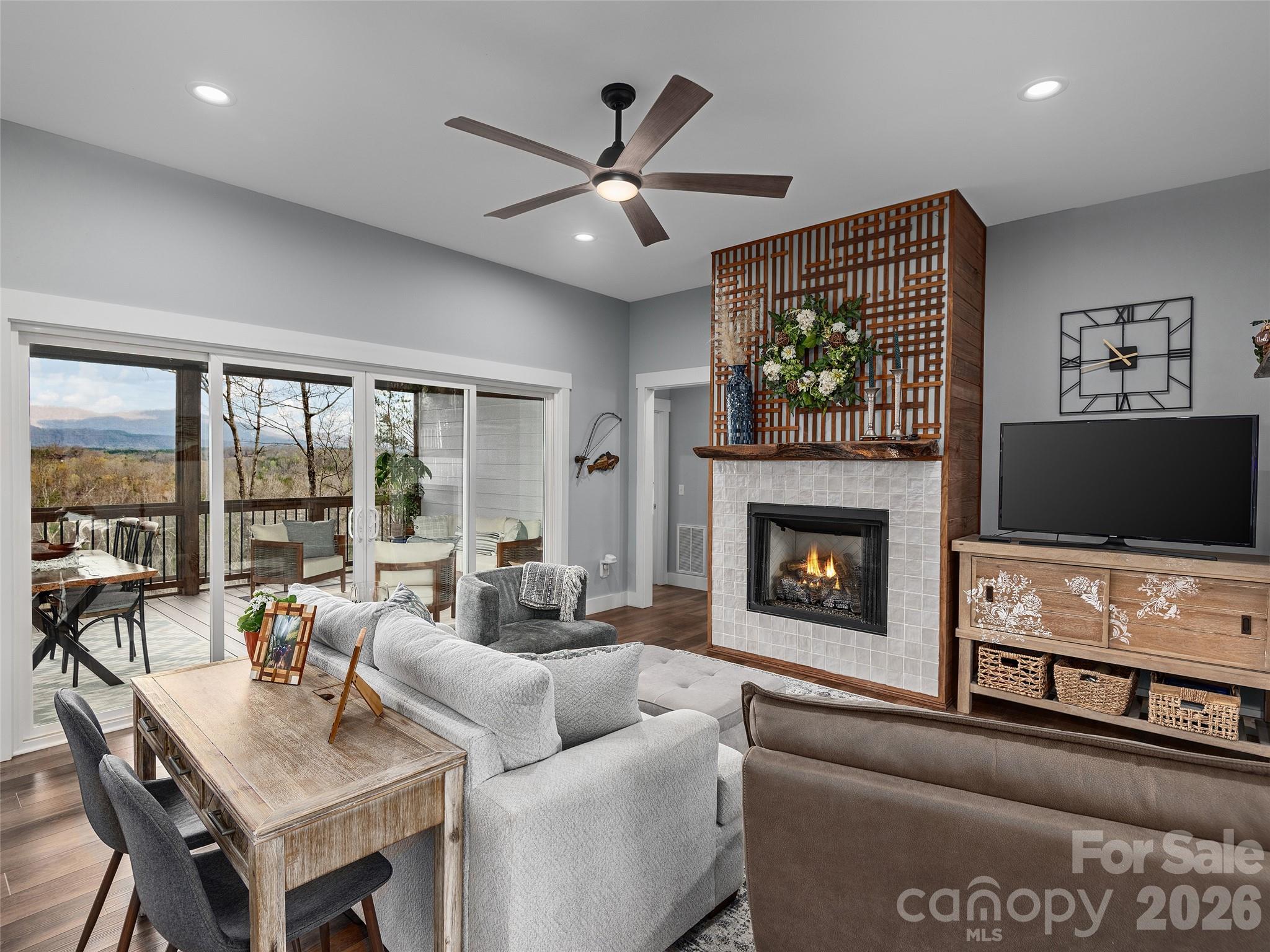 3244 Lake Adger Parkway Mill Spring, NC 28756 - Photo 5 of 44 a living room with furniture a flat screen tv and a fireplace