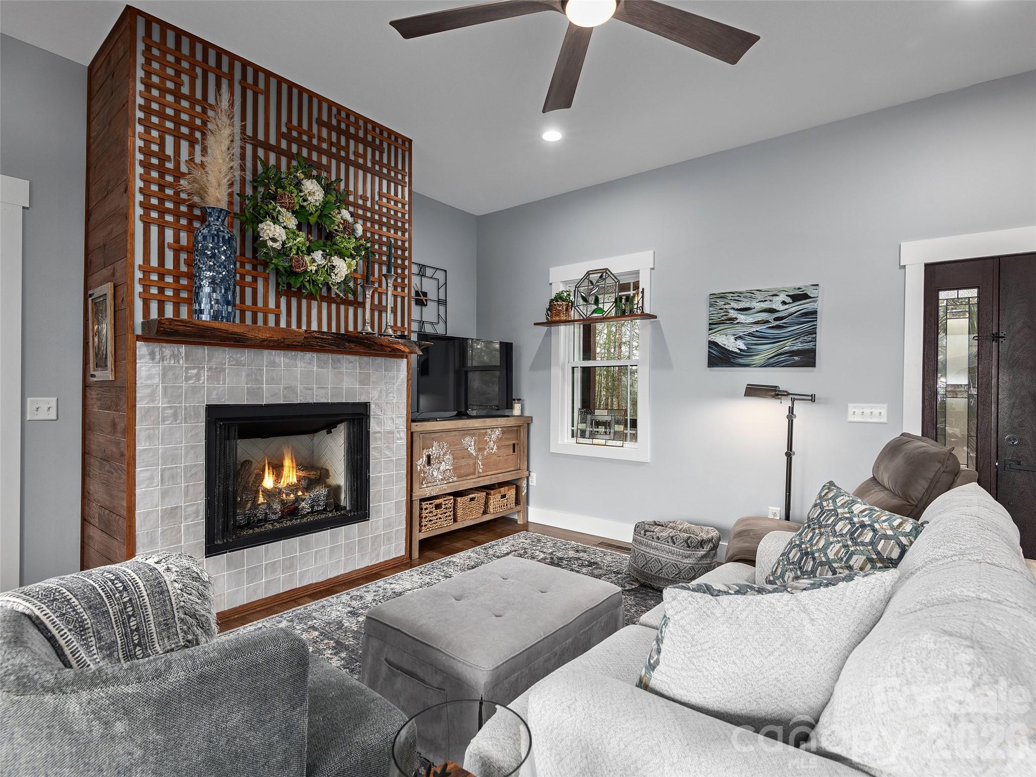 3244 Lake Adger Parkway Mill Spring, NC 28756 - Photo 8 of 44 a living room with furniture and a fireplace