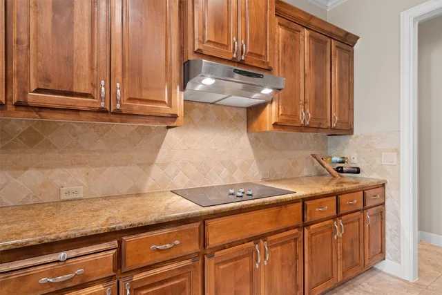 a kitchen with granite countertop cabinets and black appliances