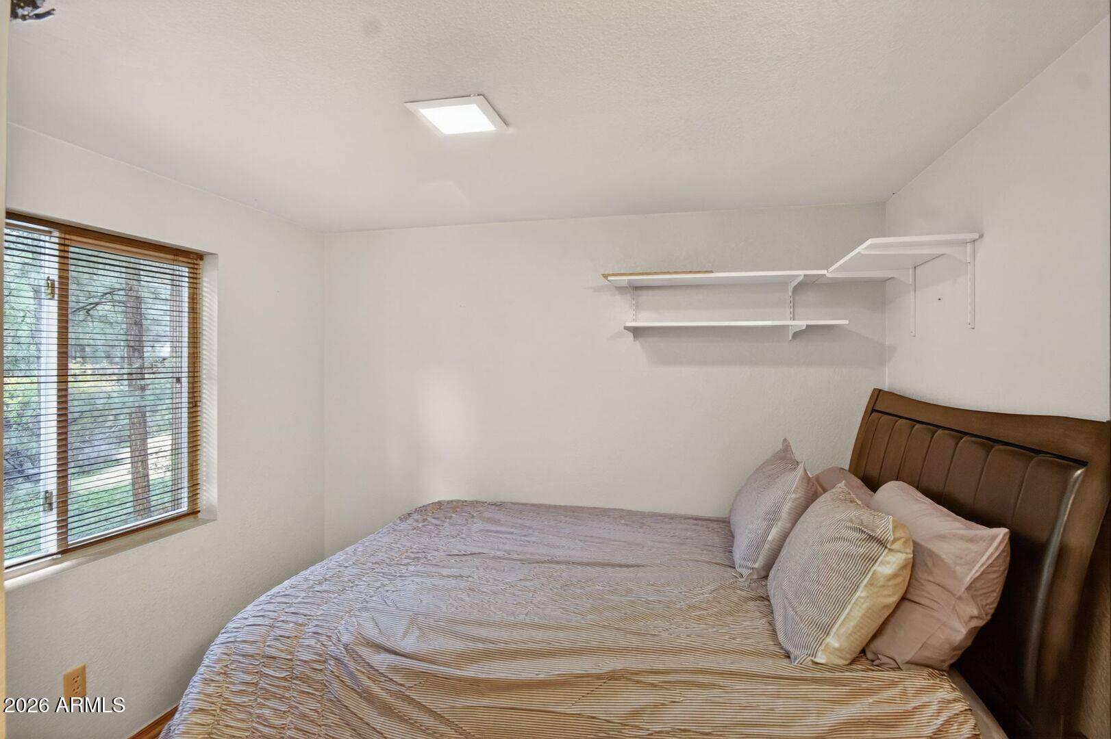 8884 Tonto Rim Drive Pine, AZ 85544 - Photo 35 of 43 a view of a bedroom with a bed and the window