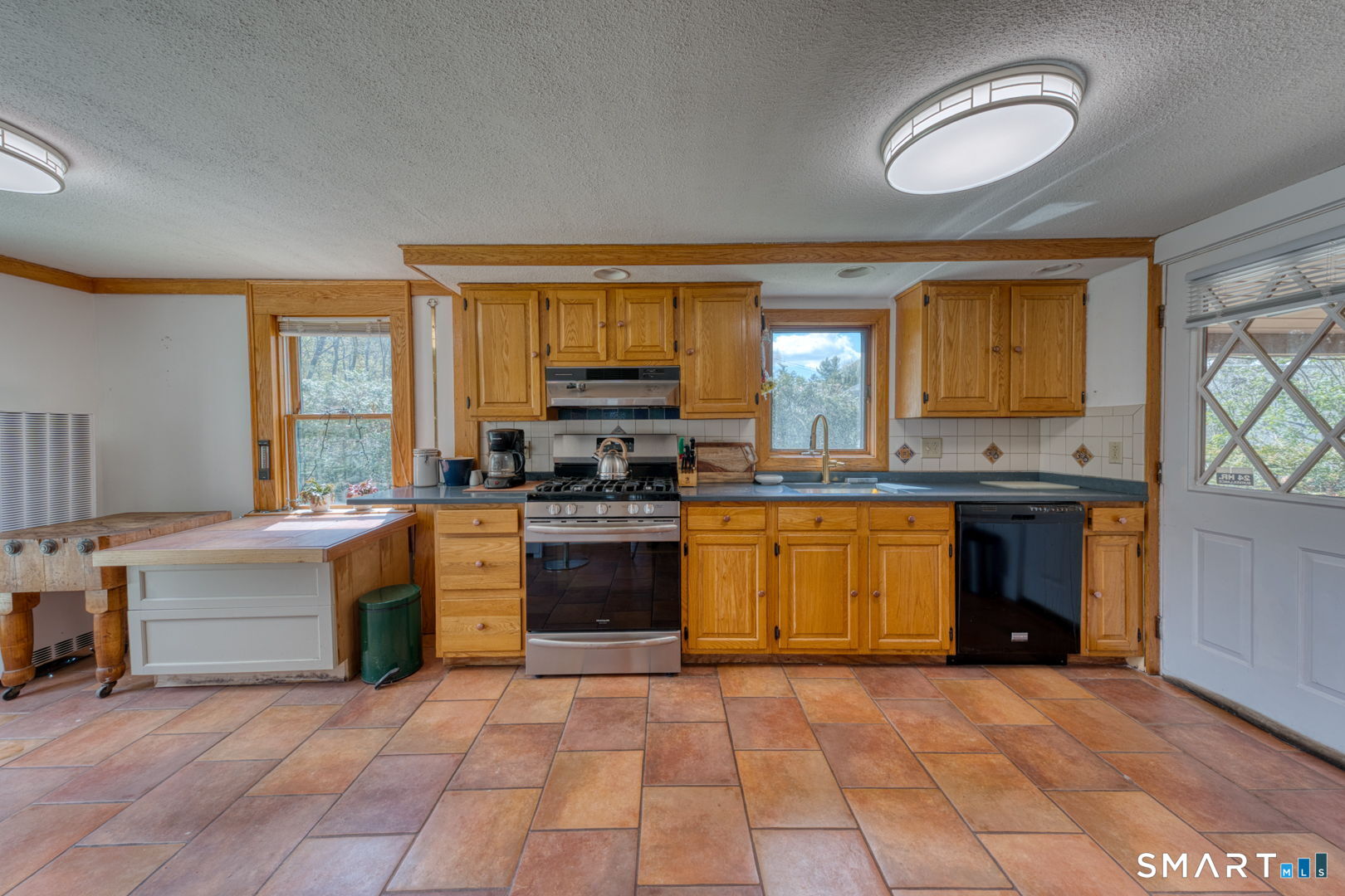 56 Tyler Lake Heights Road Goshen, CT 06756 - Photo 13 of 24 a kitchen with stainless steel appliances granite countertop a stove sink and cabinets