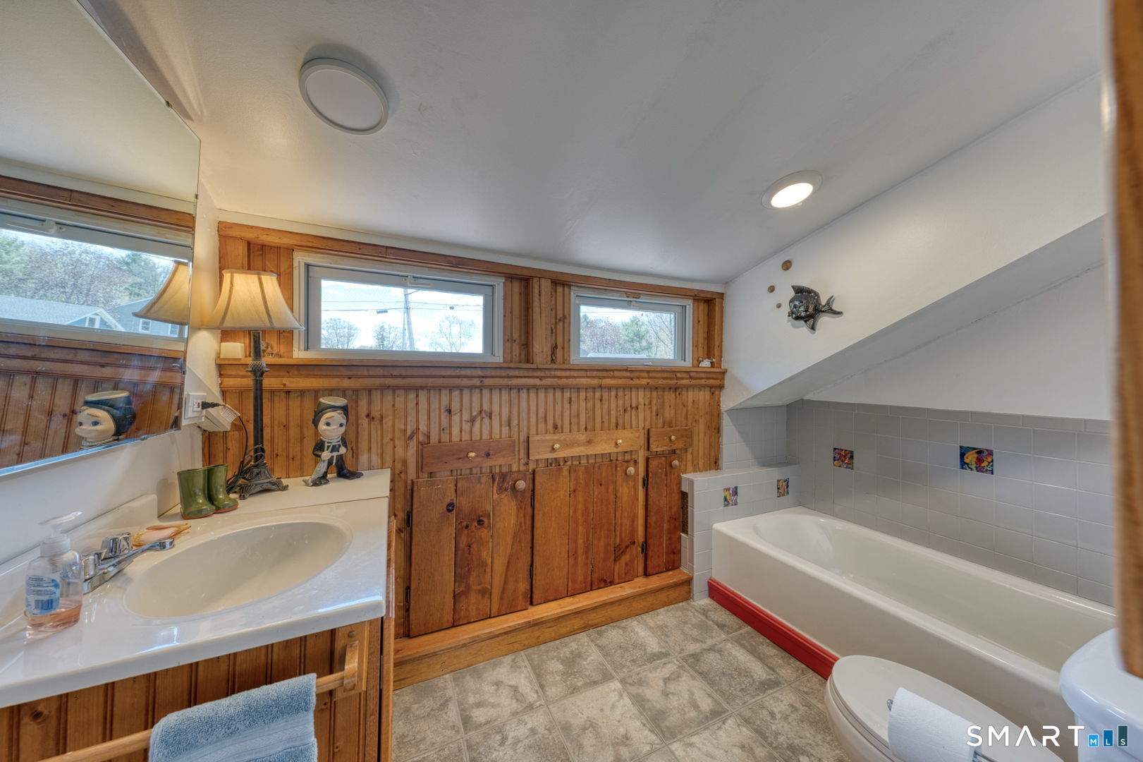 56 Tyler Lake Heights Road Goshen, CT 06756 - Photo 18 of 24 a bathroom with a sink a bathtub and a mirror
