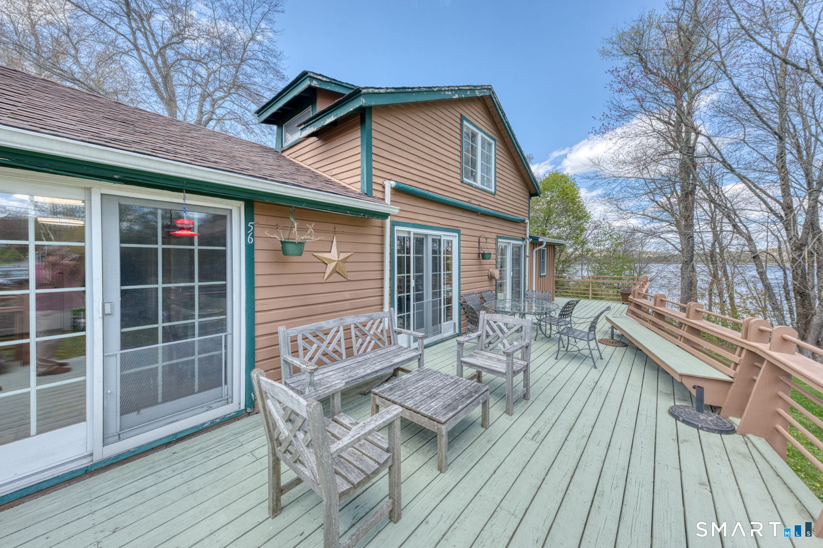 56 Tyler Lake Heights Road Goshen, CT 06756 - Photo 5 of 24 a view of house with patio outdoor seating and wooden floor
