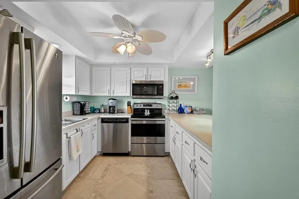 a large kitchen with a large window and stainless steel appliances