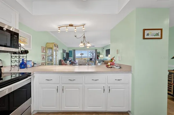 a kitchen with cabinets appliances and a sink