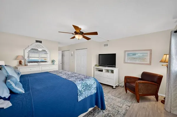 a bedroom with a bed and a chair