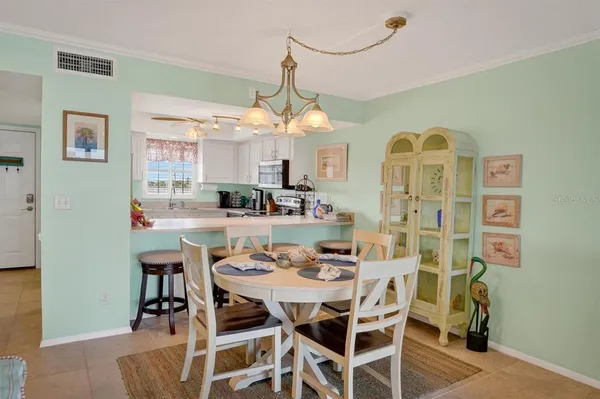 a view of a dining room with furniture and a chandelier