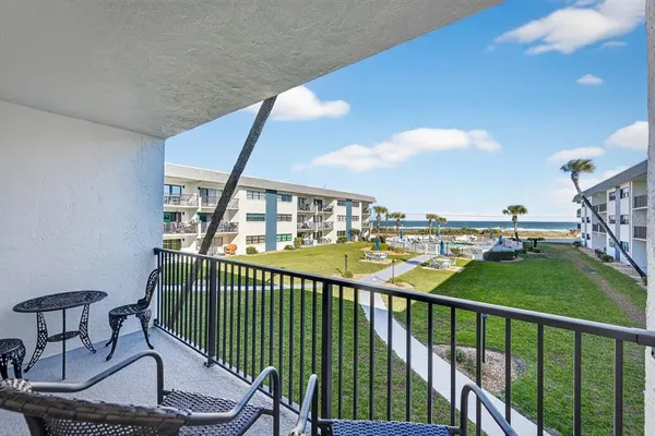 a view of a balcony with chairs