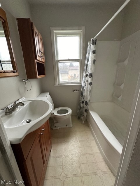 16104 Corkhill Road Maple Heights, OH 44137 - Photo 16 of 24 Full bathroom with shower / tub combo with curtain, toilet, vanity, and tile flooring