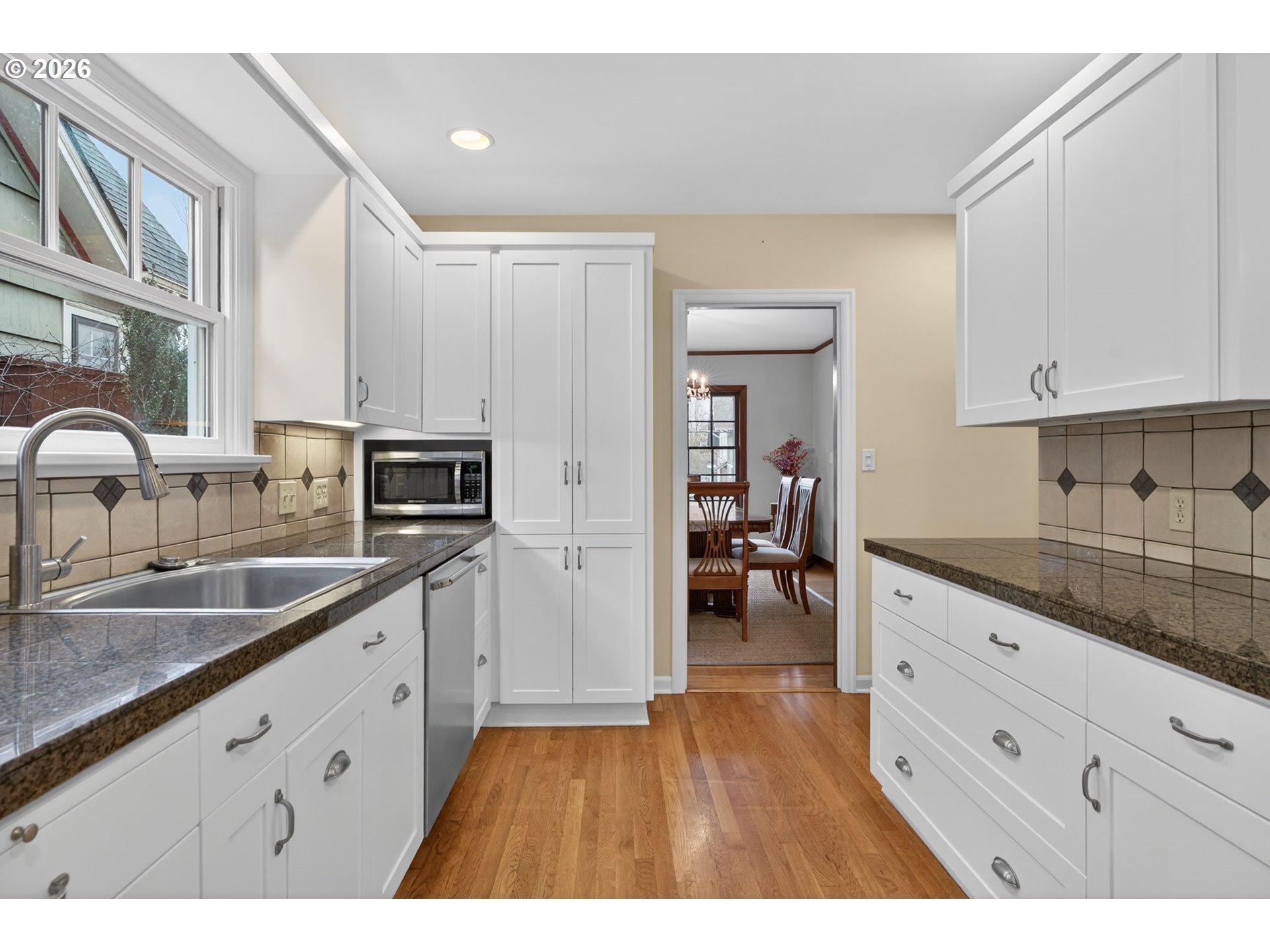 728 Northeast Royal Court Portland, OR 97232 - Photo 11 of 48 a kitchen with granite countertop a sink stove and cabinets