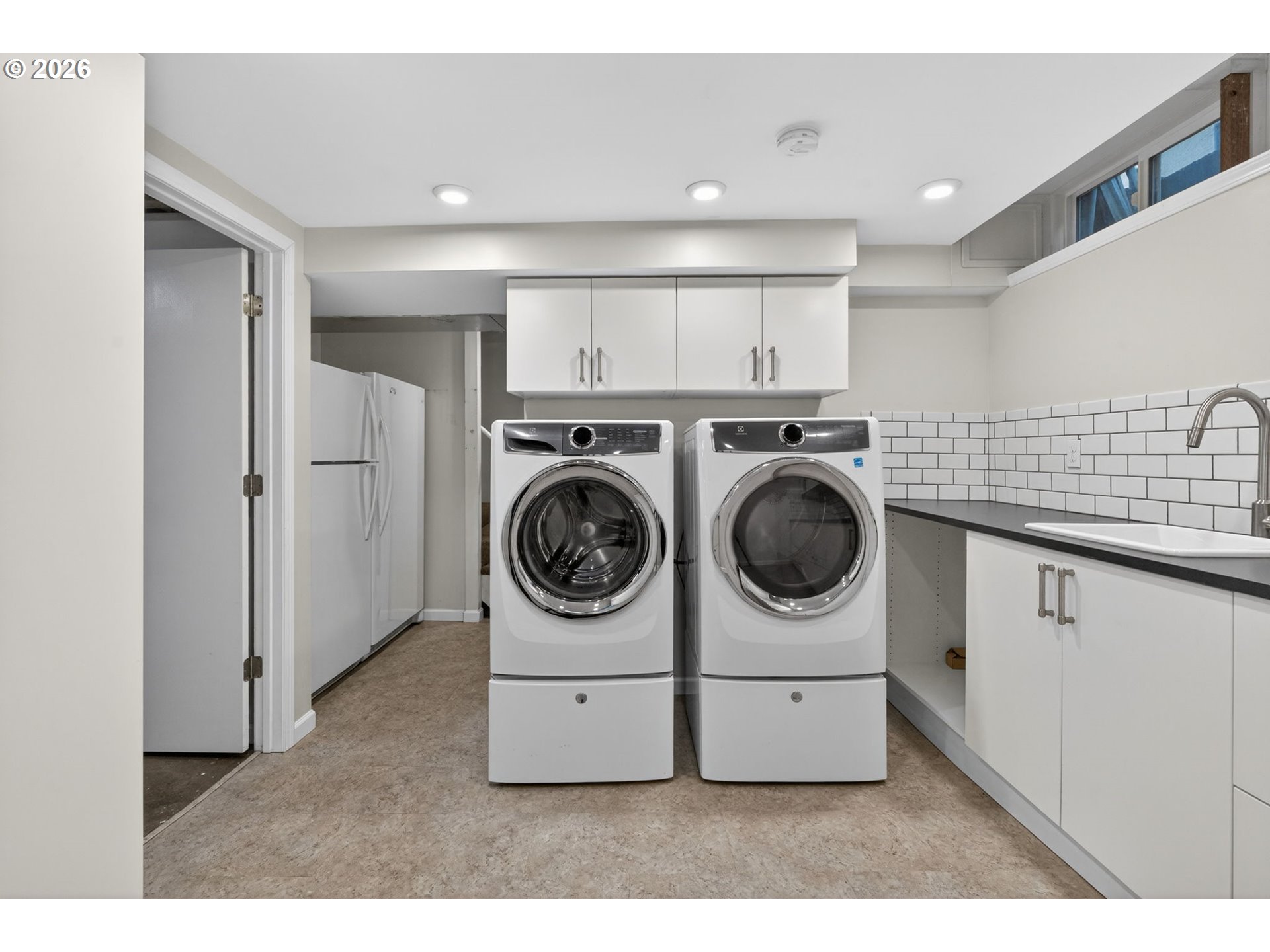 728 Northeast Royal Court Portland, OR 97232 - Photo 32 of 48 a utility room with sink dryer and washer