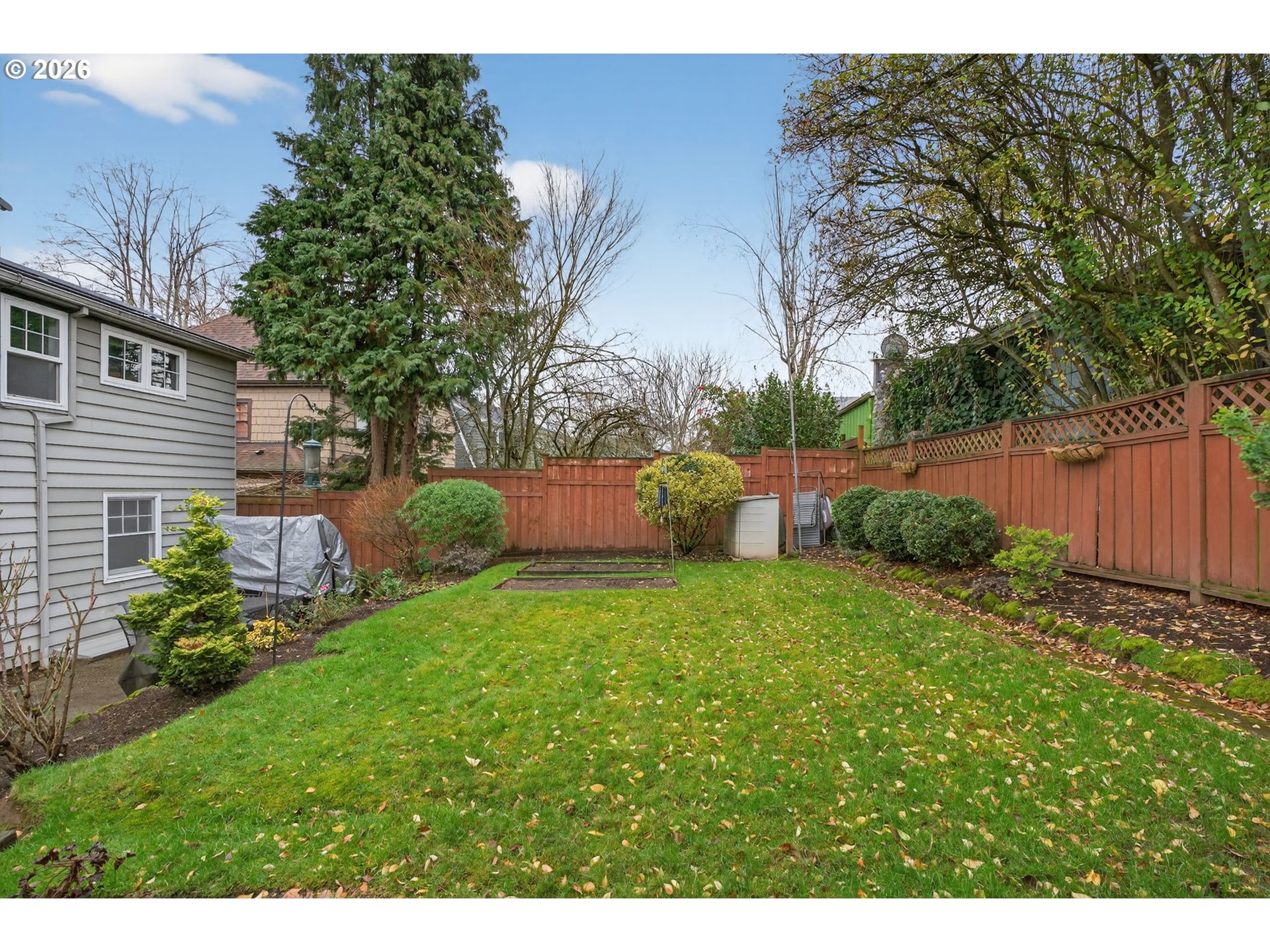 728 Northeast Royal Court Portland, OR 97232 - Photo 39 of 48 a backyard of a house with table and chairs plants and large tree