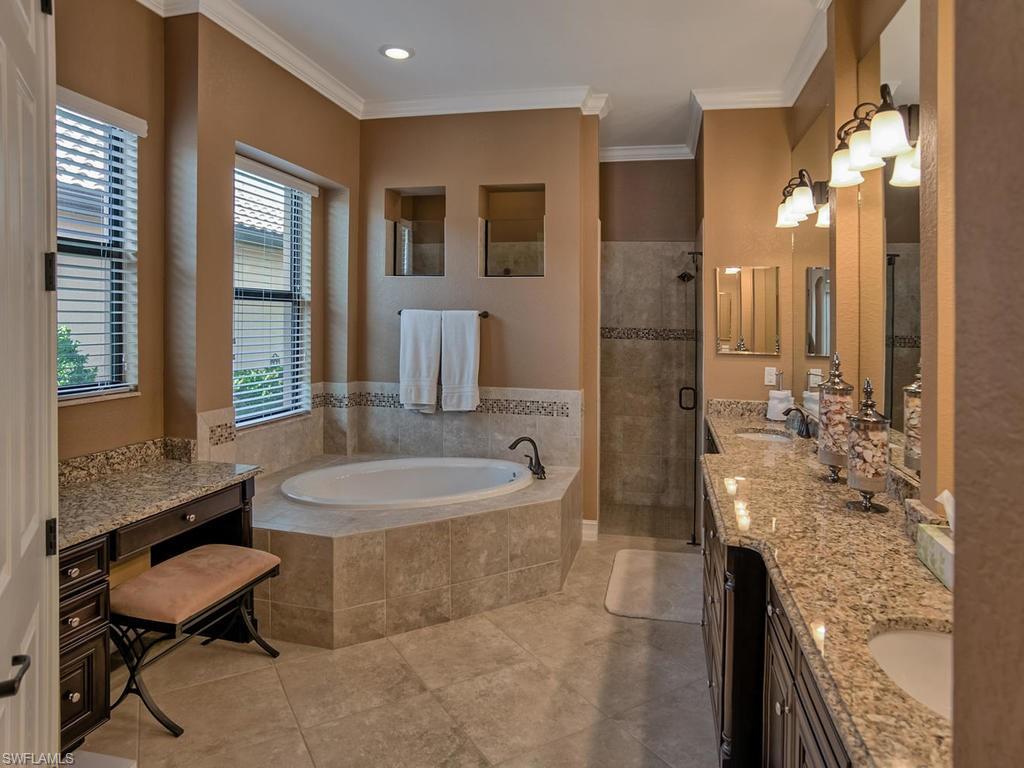 9634 Firenze Circle Naples, FL 34113 - Photo 13 of 35 a spacious bathroom with a granite countertop sink a toilet a mirror and shower