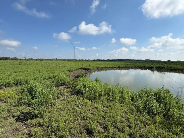 a view of a lake with houses in the back