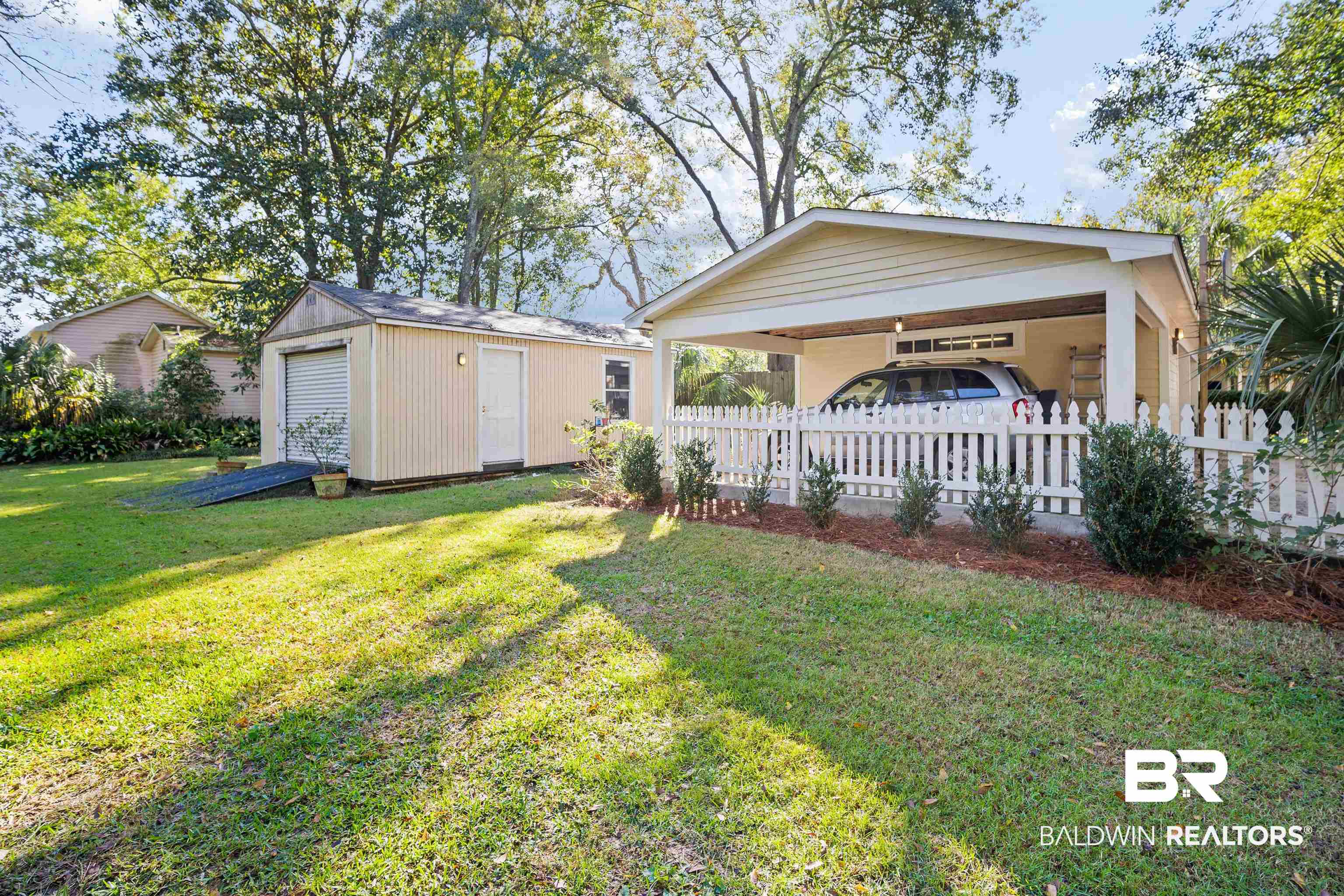 1314 Dauphin Street Mobile, AL 36604 - Photo 56 of 61 View of yard with an outbuilding and a carport