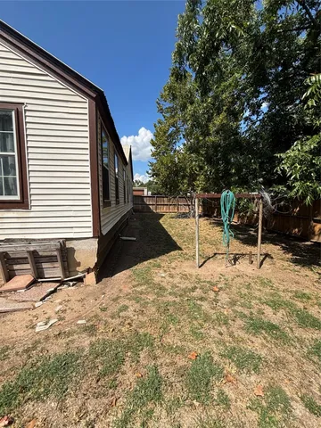 a backyard of a house with table and chairs