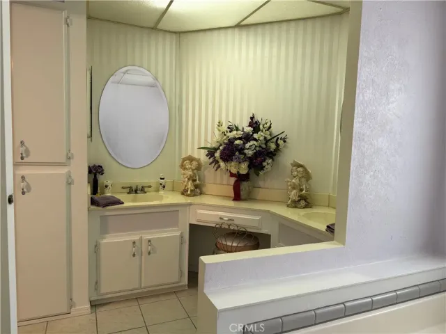 a bedroom with bed and a large mirror