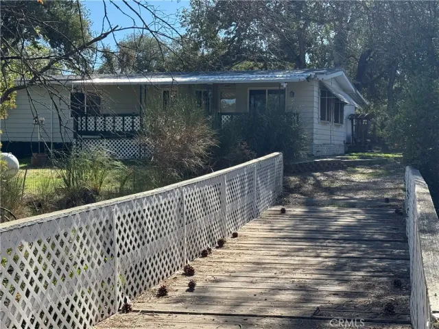 a view of swimming pool with a yard and large trees