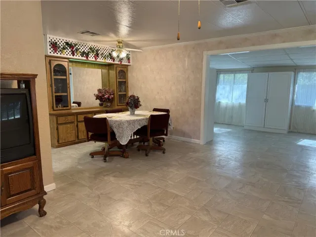 a dining room with furniture and window