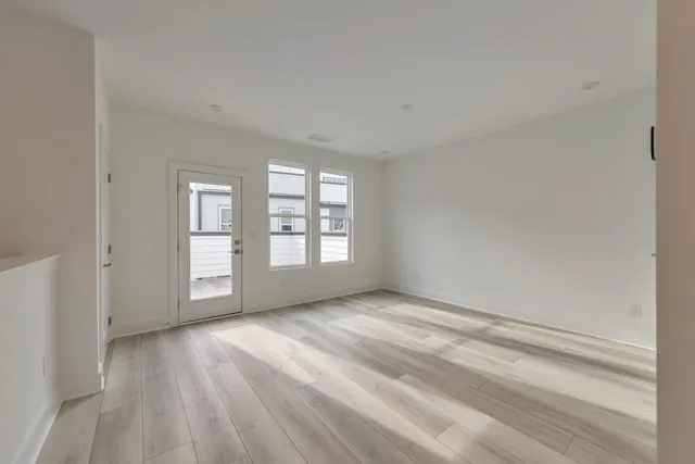 a view of a room with a dishwasher and a wooden floor