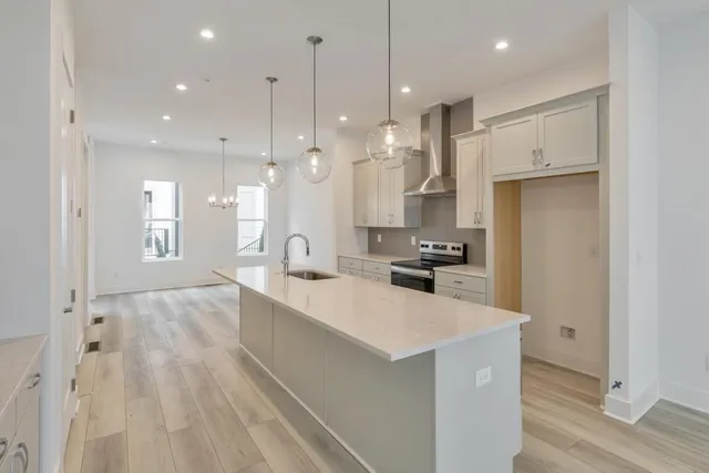 a large kitchen with a large counter top appliances and cabinets