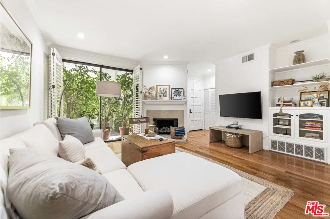 1108 18th Street, Unit 5 Santa Monica, CA 90403 - Photo 1 of 11 a living room with furniture fireplace and a flat screen tv