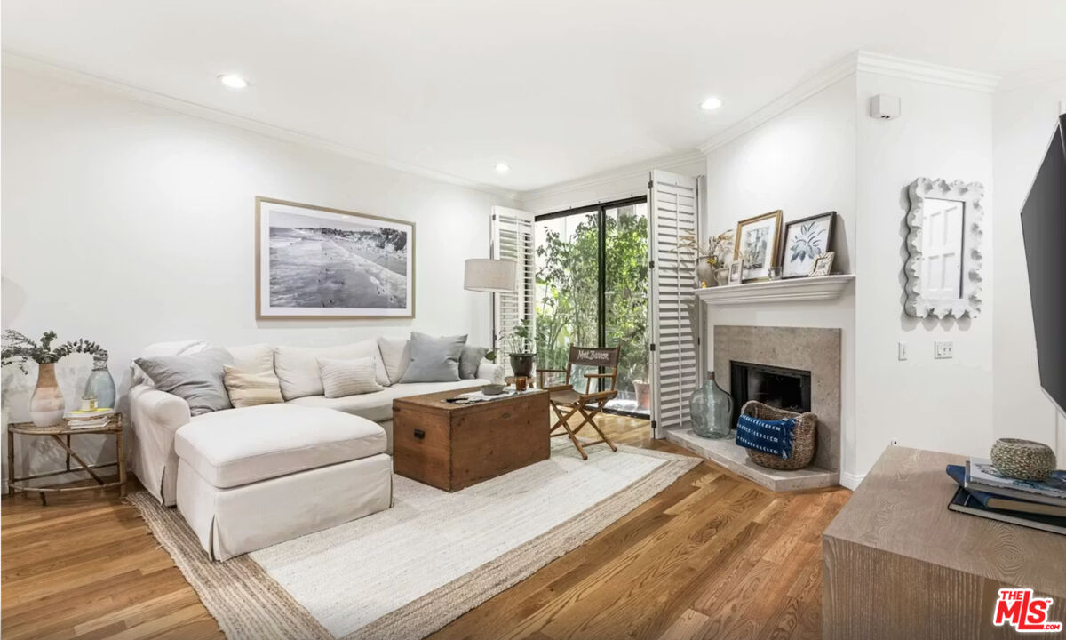 1108 18th Street, Unit 5 Santa Monica, CA 90403 - Photo 2 of 11 a living room with furniture large window and a fireplace
