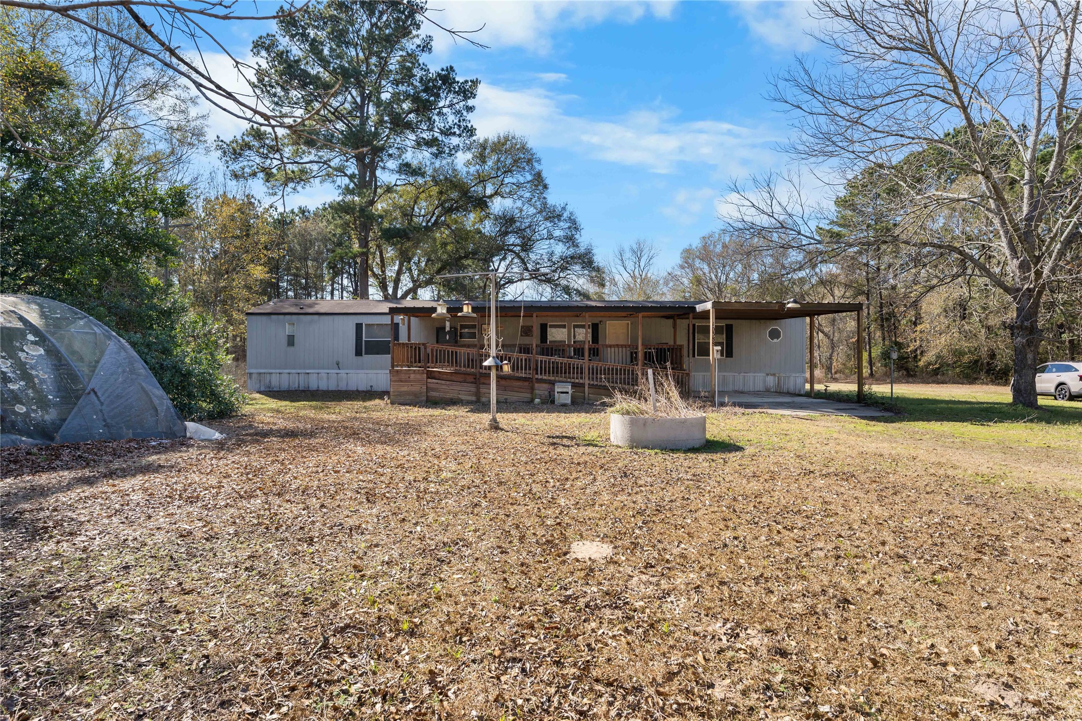 10388 Rutherford Circle Cleveland, TX 77328 - Photo 6 of 14 Manufactured home featuring a larger rear primary bedroom with an en-suite bath offering a separate tub and shower.Kitchen includes ample cabinet storage; utility room located within the home.Covered back porch providing additional outdoor space.