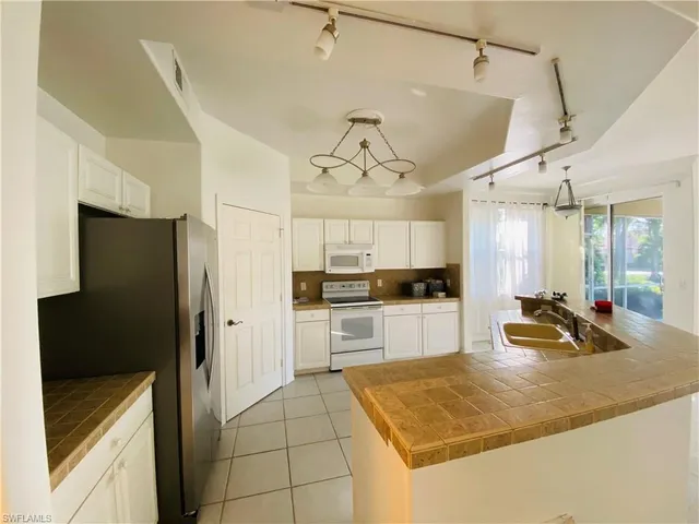 a kitchen with refrigerator and cabinets