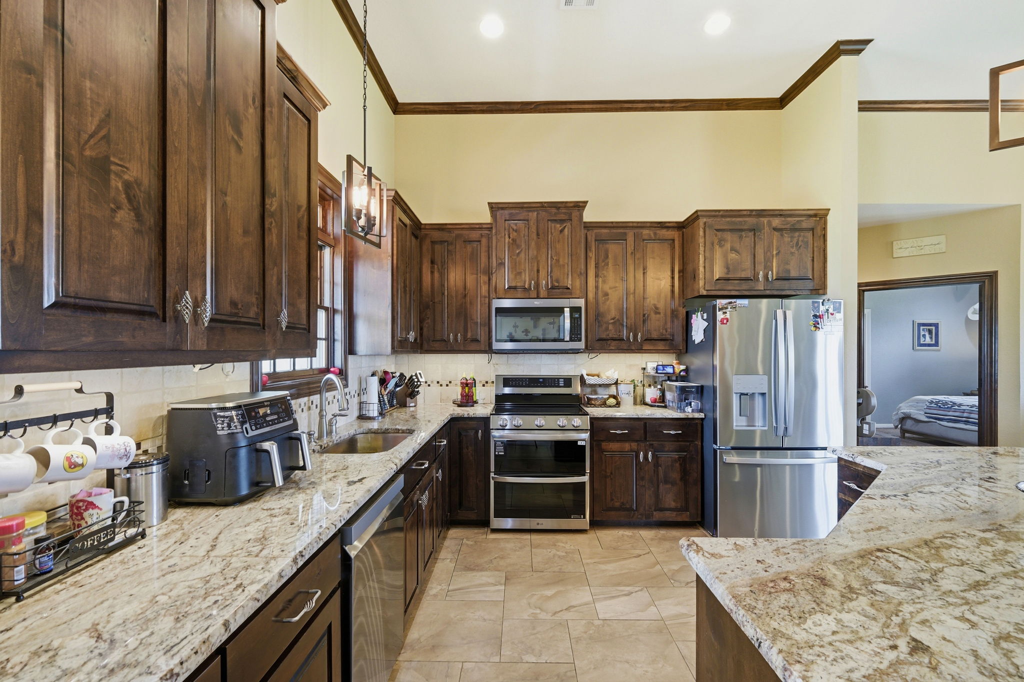 701 County Road 107 Georgetown, TX 78626 - Photo 16 of 30 a kitchen with stainless steel appliances granite countertop a sink stove and refrigerator