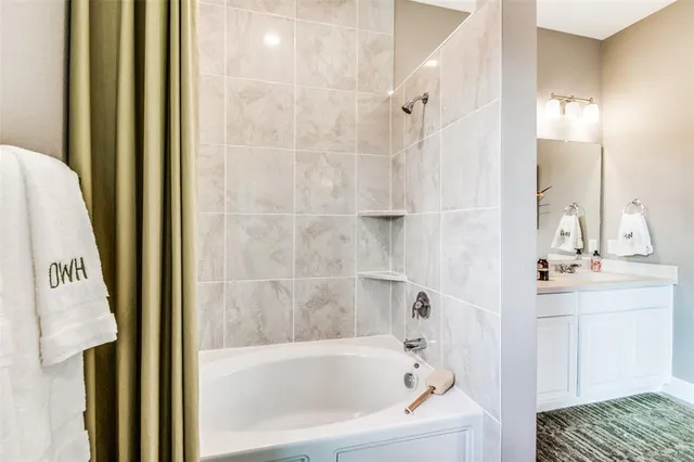 a bathroom with a bathtub and shower