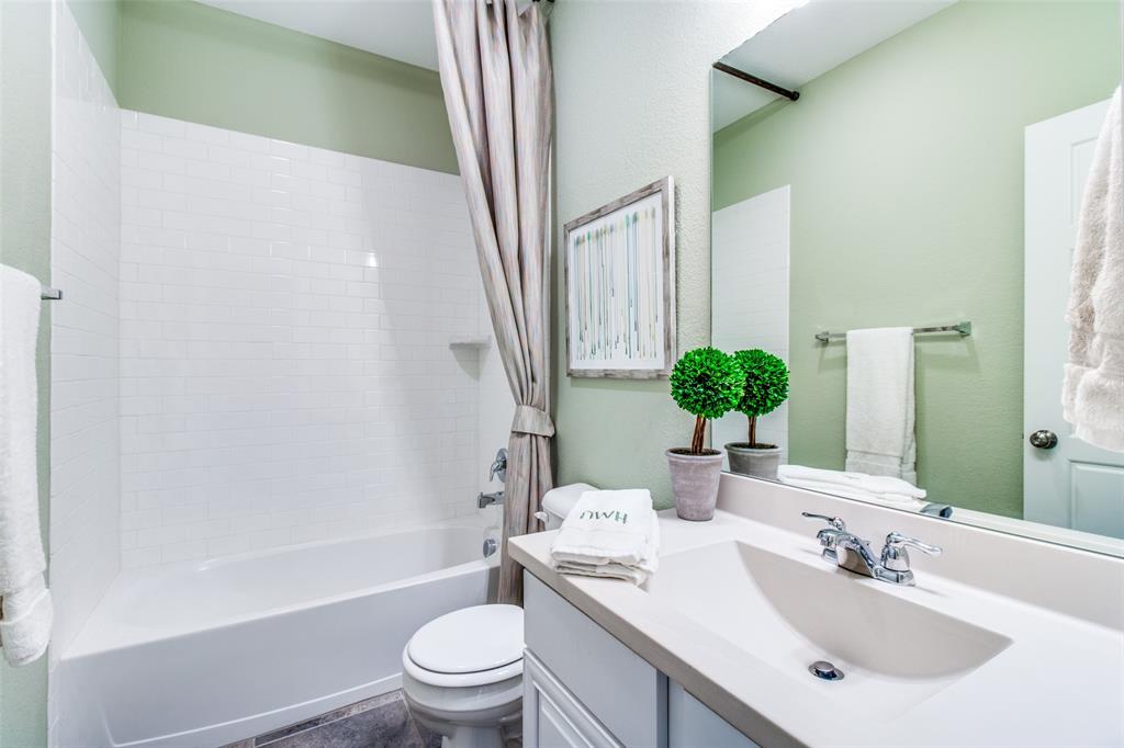 1605 Cedar Crest Drive Forney, TX 75126 - Photo 18 of 26 a bathroom with a sink a toilet a tub and shower