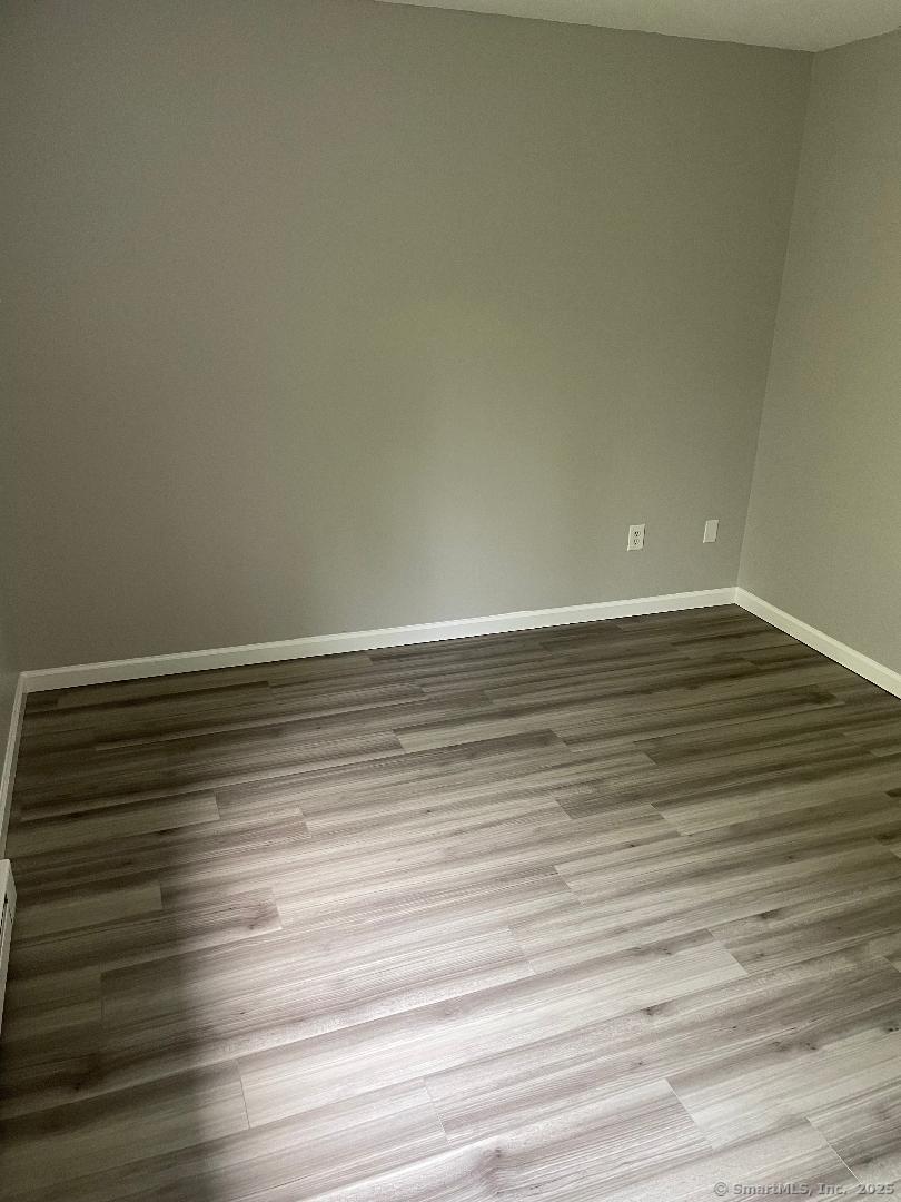155 Unit 2 Bristol Street Thompson, CT 06277 - Photo 13 of 18 a view of an empty room with wooden floor