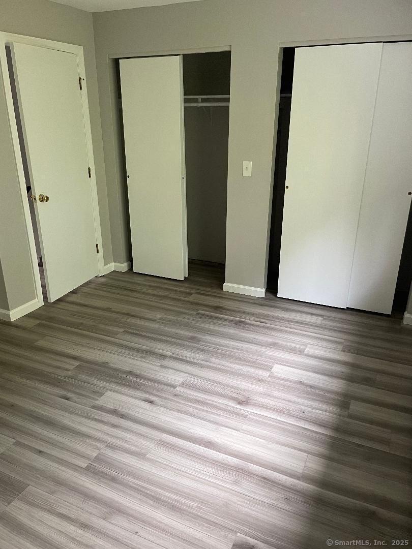 155 Unit 2 Bristol Street Thompson, CT 06277 - Photo 14 of 18 a view of an empty room with wooden floor