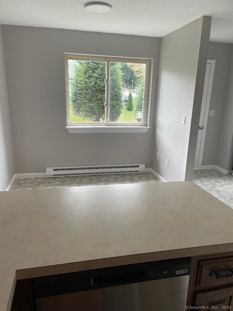 155 Unit 2 Bristol Street Thompson, CT 06277 - Photo 4 of 18 a room with wooden floor and a window