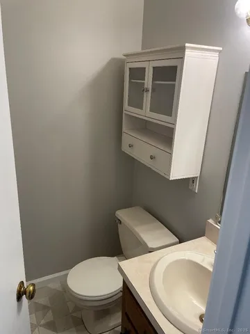 a white toilet sitting next to a sink