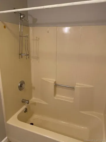 a bathroom with a shower and a shower