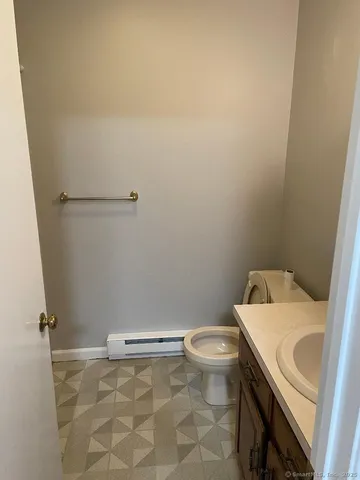 a white toilet sitting next to a shower